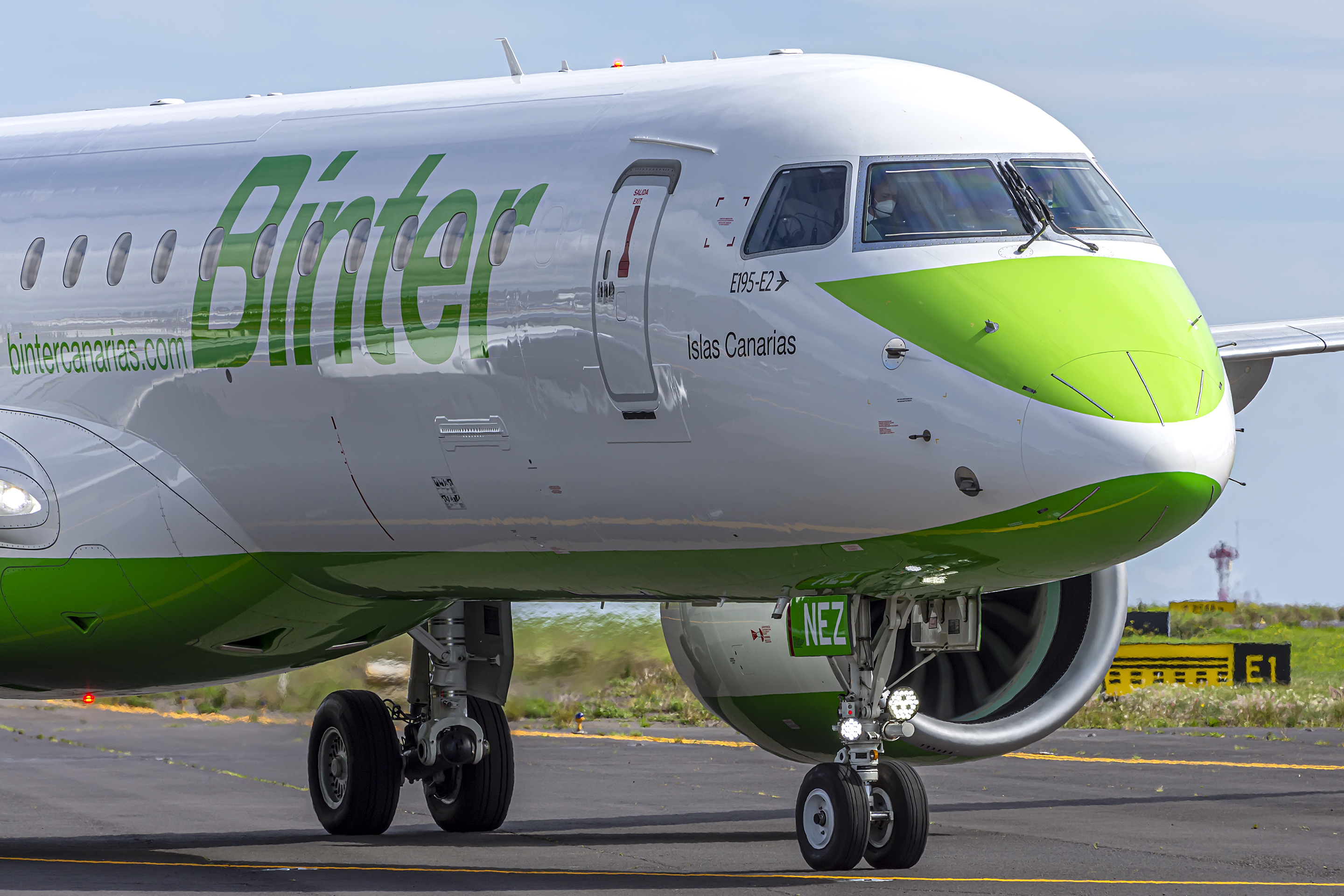 Front view of the nose of an Embraer aircraft in parking