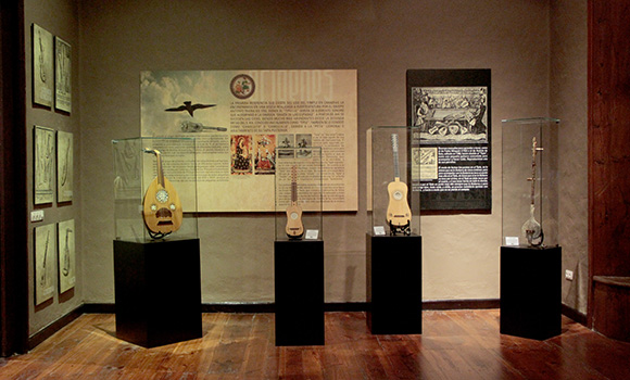 Alguns instrumentos de cordas nas suas caixas de exposição no interior do museu