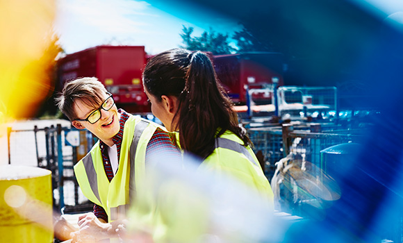 Two workers working in an industrial area