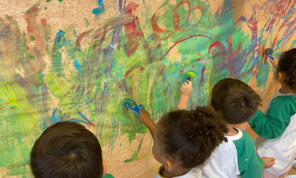 Group of children painting a mural