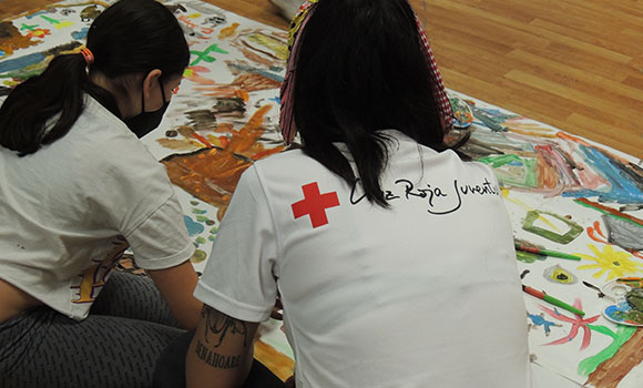 Two people painting a mural