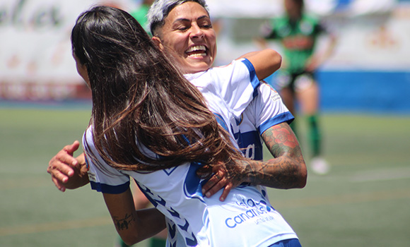 Alcune giocatrici di calcio festeggiano abbracciandosi.